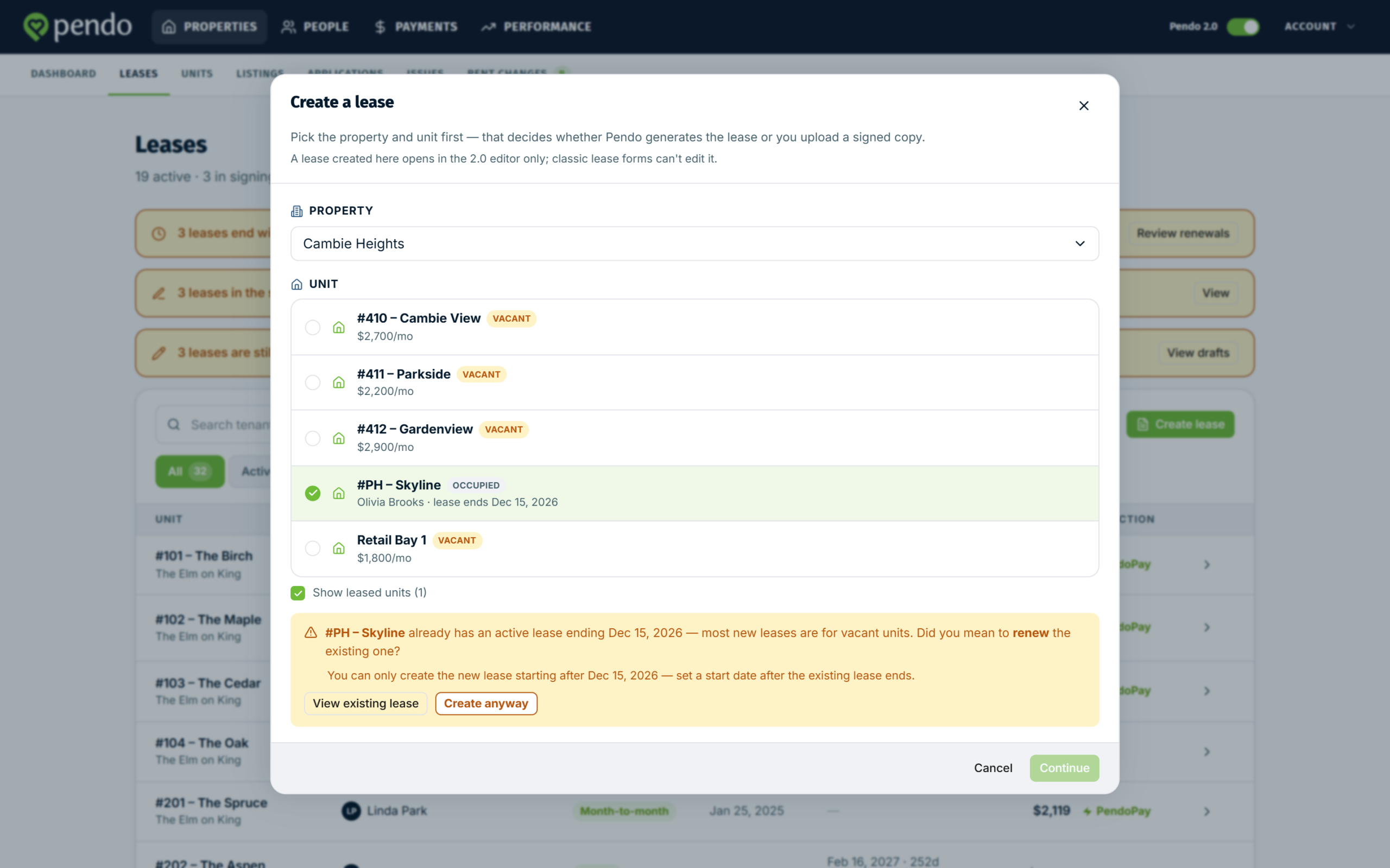 The create-lease wizard showing the amber overlap notice on a unit that already has a live lease